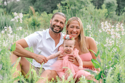 a family of five sitting on a park at coker arboretum and having their photo taken by rosa ashdown