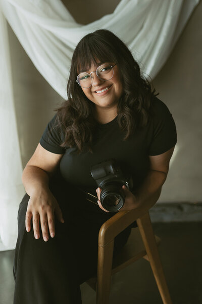 professional headshot of Danielle Rose, a wedding and elopement photographer based in Wichita, Kansas, showcasing a warm smile and confident pose during her branding session.