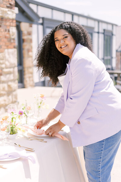 Sofi Melvin, Kansas City wedding planner, setting a table