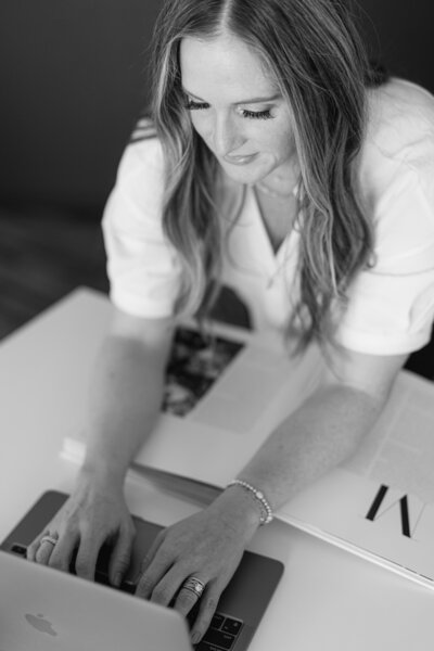 A woman typing on a laptop