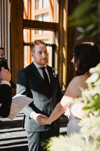 Couple looking at each other during mountain wedding ceremony