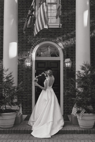 black and white wedding portrait in from of a brick building