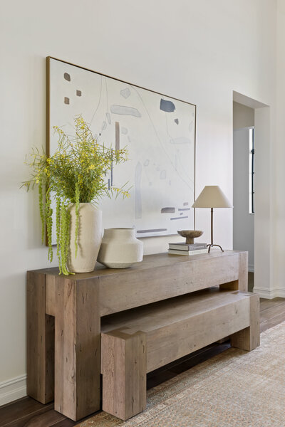 Entryway With Wooden Floating Shelf and Neutral Decor