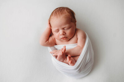 Infant posed for Newborn Photoshoot in Charleston, SC.
