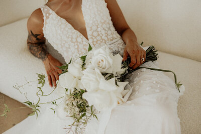 Bride holding flowers while wearing a dress