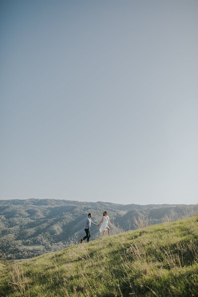 rebecca skidgel photography couple walking up hill