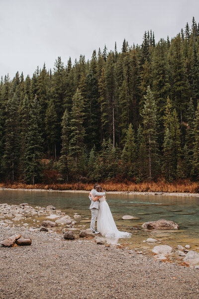 Newlyweds hug one another at Banff National Park for their elopement