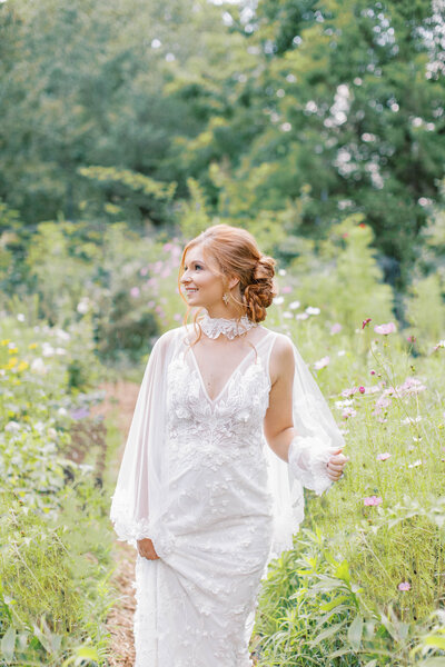 Bride walking through wild flower field