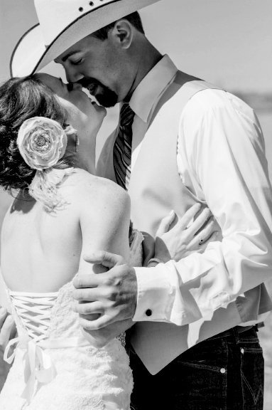 Black and white photo of bride and groom about to kiss