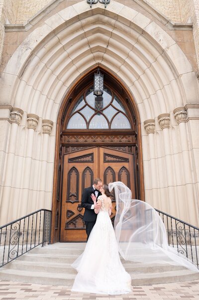 Bride and groom kiss at the alter at Notre Dame's Basilica