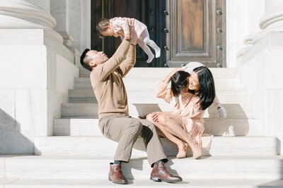 Young family playing together on steps in washington dc