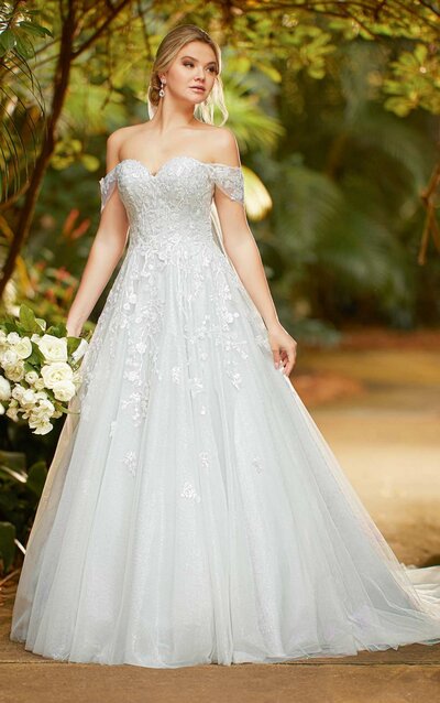 BLUE PRINCESS BALLGOWN WITH SPARKLING LACE Your future is certainly bright with this Essense of Australia gown. Style D3221 emulates timeless princess style with its sweetheart neckline, detachable off-shoulder straps and sparkling lace details. The fully constructed bodice reinforces your figure with enhanced shaping and support. Lace softly extends from the bodice and throughout the full, decadent ballgown skirt for a traditional feel–while the sky-blue fabric throughout the silhouette keeps this style ahead of its time. Available with fabric-covered buttons or a lace-up back feature, this gown is also available in plus sizes.