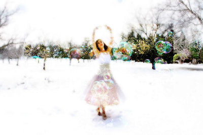 Dancer in snow with bubbles