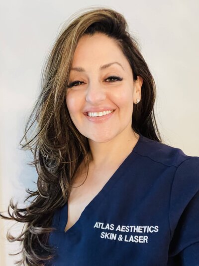 Atlas smiling in her scrub uniform