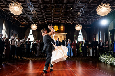 Jessica and Nick's joyful wedding portrait at Julia Morgan Ballroom featuring classical columns and marble architecture - San Francisco historic venue wedding photography