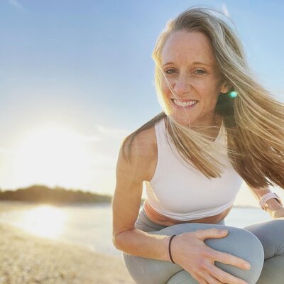 Cara F smiling on the beach