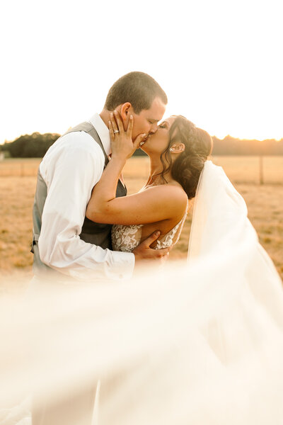 couple kissing at golden hour