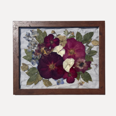 Pressed floral frame filled with white flowers.