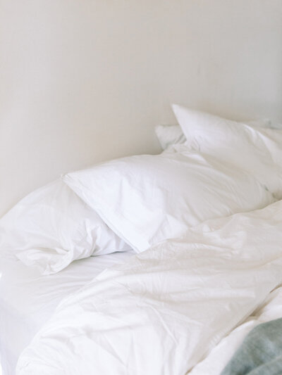 A linen bed, meant to represent chronic fatigue.