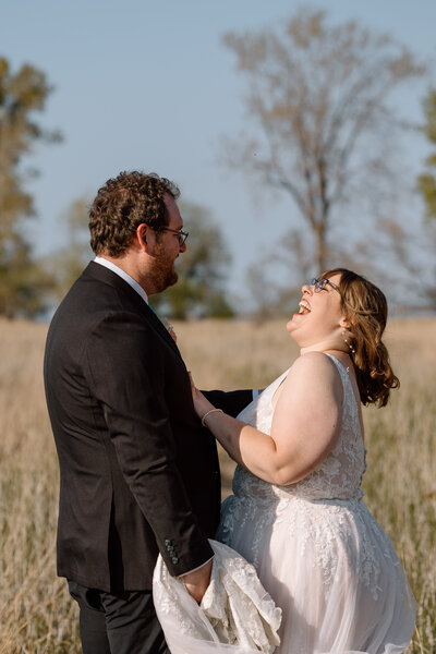 Bride and groom laughing at Headlands Beach State Park.