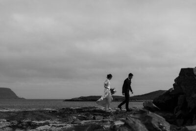 bride and groom walking on the beach