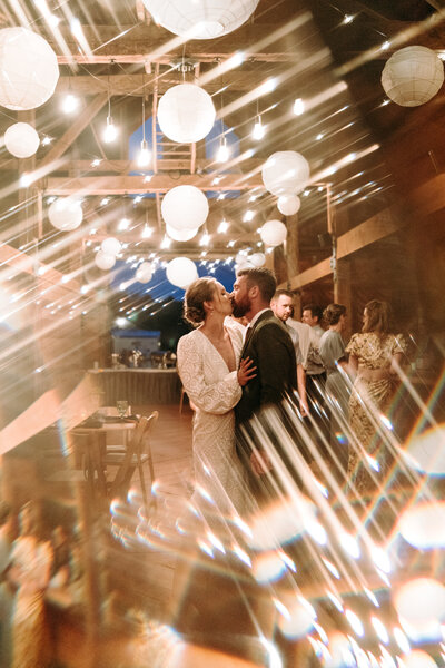 fractal light effect inside maine barn wedding a creative photo of the couple with light streaks  funky wedding photography