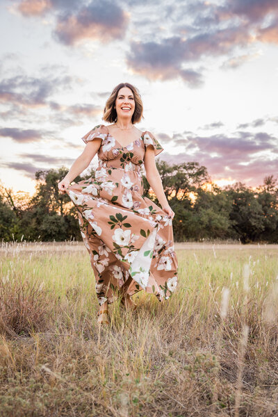 portrait of a lady spinning in her dress at sunset