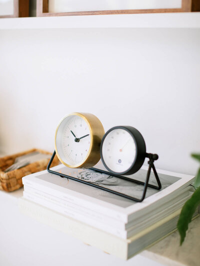 Aubre wearing a white button down shirt standing in front of a sun drenched window
