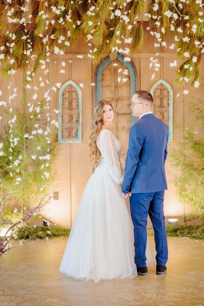 A beautiful barn wedding venue, Carolina Country Weddings, surrounds the engaged couple.