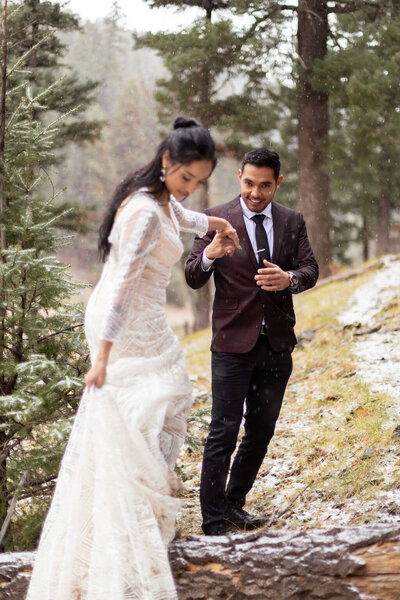 Couple embracing during their winter forest elopement in Utah, photographed by Lamblight Photography