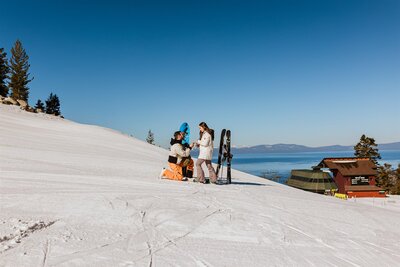 ake Tahoe winter proposal on ski slopes with snowboards and champagne