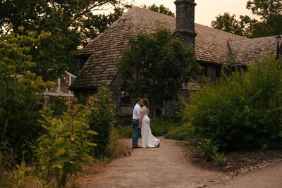 Sunset portraits at Groesbeck Estate in Milford Ohio of wedding couple in front of the venue