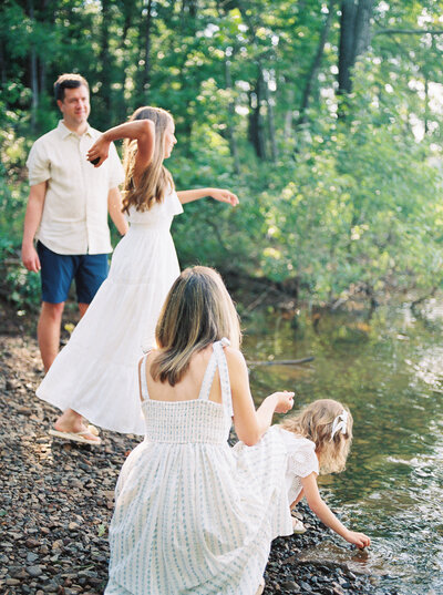 Young family throws rocks into Greers Ferry Lake in Central Arkansas