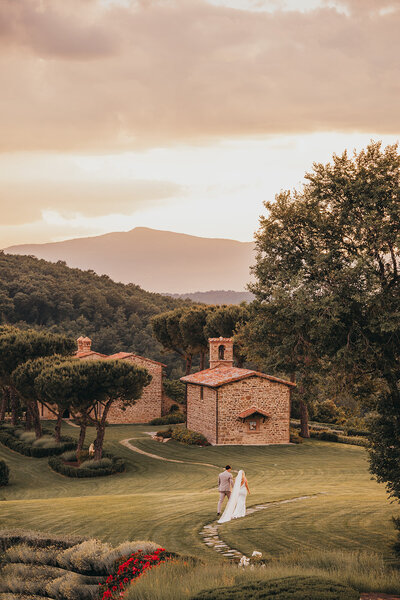 bride and groom walk together at tuscan venue