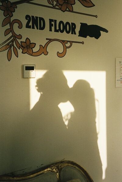 Shadow of a couple kissing on a wall.