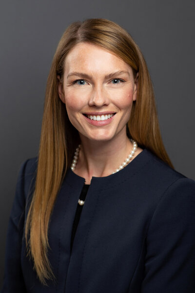 Headshot taken of business woman in Centerville, Utah against a gray backdrop.