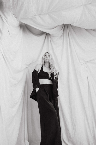 woman looks up under fabric