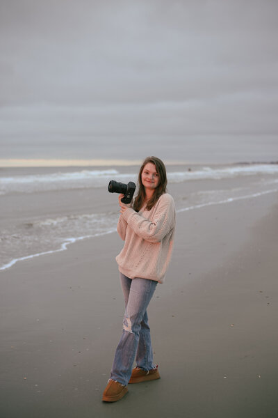 photographer posing on the beach with the camera charleston south carolina 