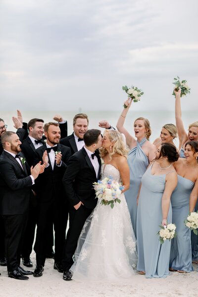 bride and groom with bridal party pose at clearwater opal sands, fl