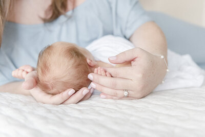 mom holding baby's head by Nashville Newborn Photographer Kristie Lloyd