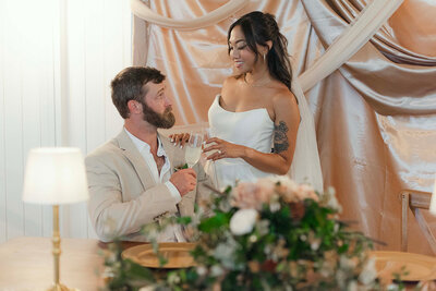 Bride and groom sharing a toast during rustic wedding reception in East Tennessee