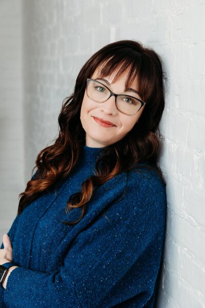woman-leaning-against-wall