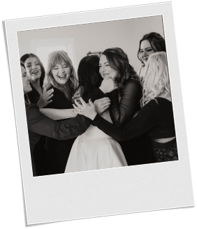 A bride hugging her friends for their first look