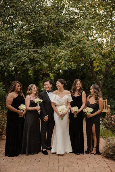 Bride laughs with wedding party members at the Denver Botanic Gardens