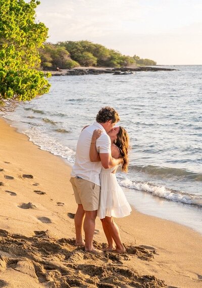 couple-kissing-sunset-beach-proposal-waikoloa-kona-big-island-hawaii