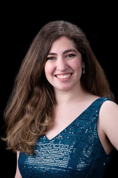 Nicole from Charizma Entertainment, smiling in a teal dress, Chicago DJ event coordinator and client liaison