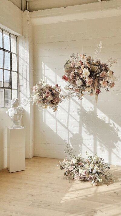 Natural lighting with floating floral clouds and greek statue