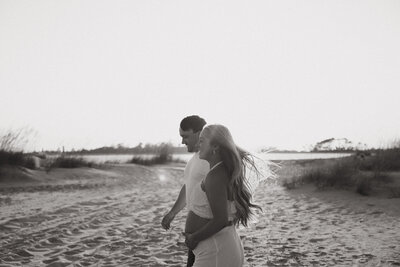 Couple walking along the beach at sunset together