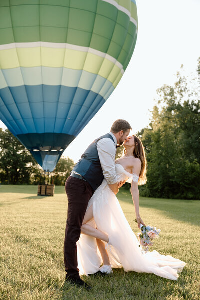 Bride holding up a bouquet of flowers during a beach elopement in Michigan.
