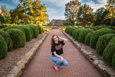 A graudating senior students takes photos at Oklahoma State Univeristy.